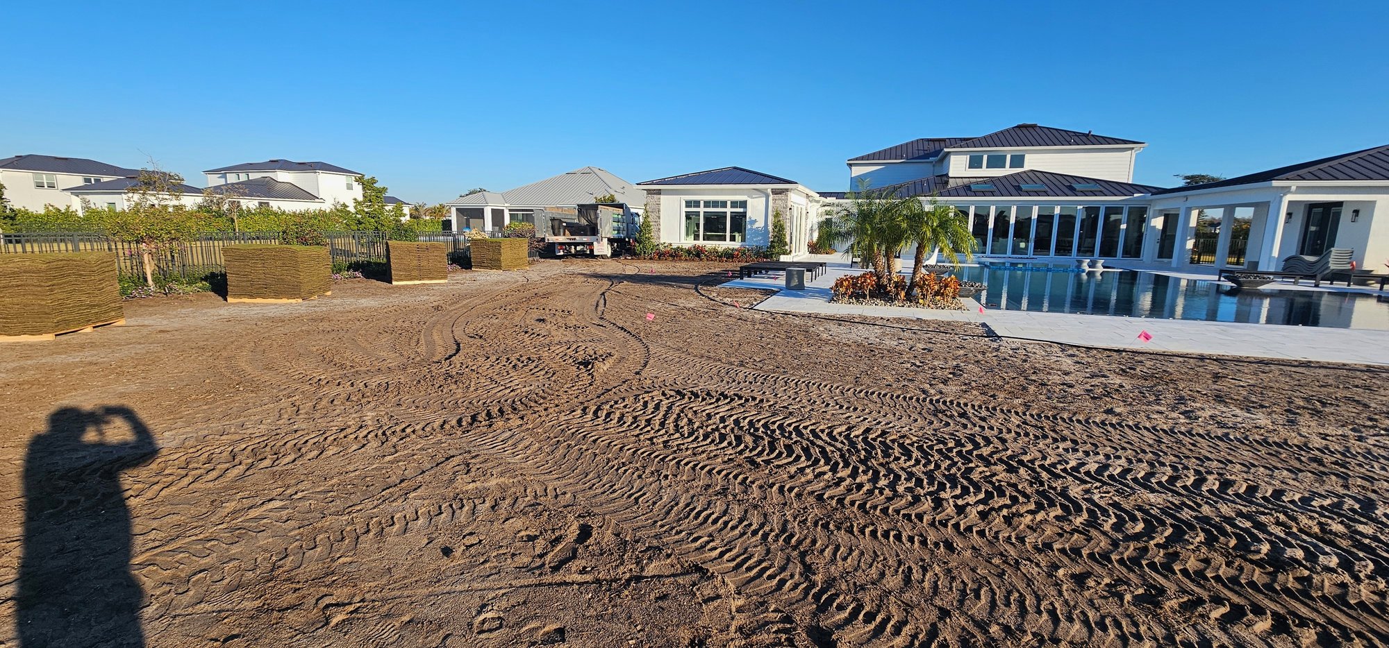 Before — bare ground at luxury estate before sod installation