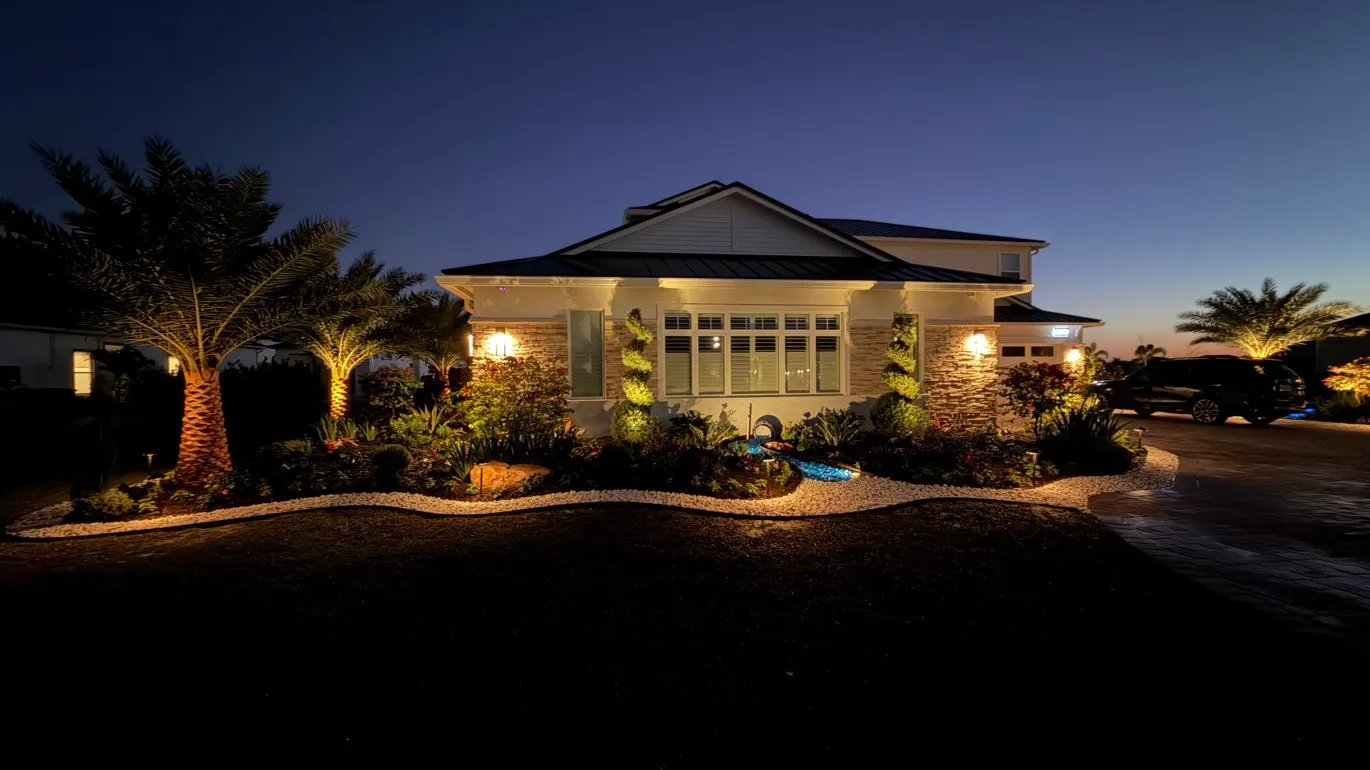 Custom landscape lighting illuminating estate home at twilight